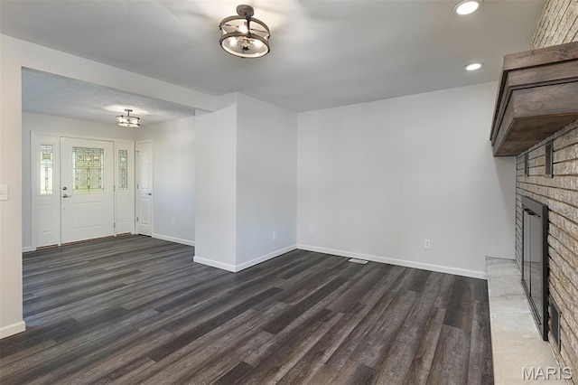 5 Lakeshore Dr, New Baden, IL 62265 - unfurnished living room with a chandelier, wood finished floors, recessed lighting, and a brick fireplace