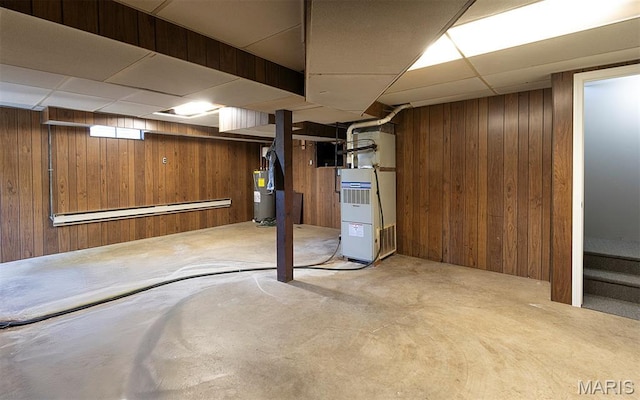 5 Lakeshore Dr, New Baden, IL 62265 - finished below grade area featuring electric water heater, wooden walls, a drop ceiling, a baseboard radiator, and heating unit