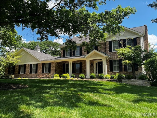 2032 Wilson Ridge Ln, Chesterfield, MO 63005 - view of front of house with a front lawn, a chimney, and brick siding
