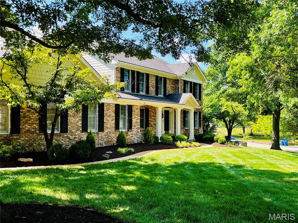 2032 Wilson Ridge Ln, Chesterfield, MO 63005 - view of front facade featuring a front lawn and brick siding
