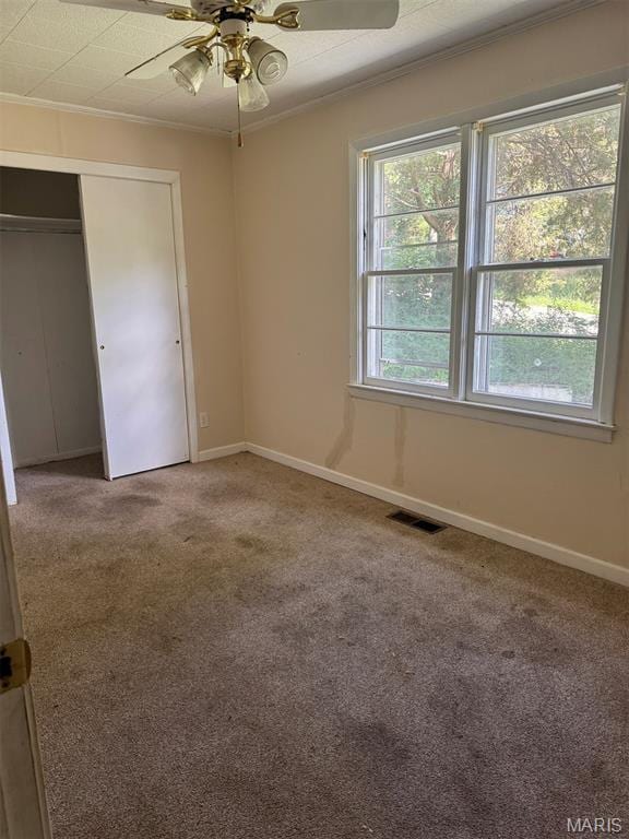 935 Pershing St, Poplar Bluff, MO 63901 - unfurnished bedroom featuring ornamental molding, carpet floors, a closet, and ceiling fan