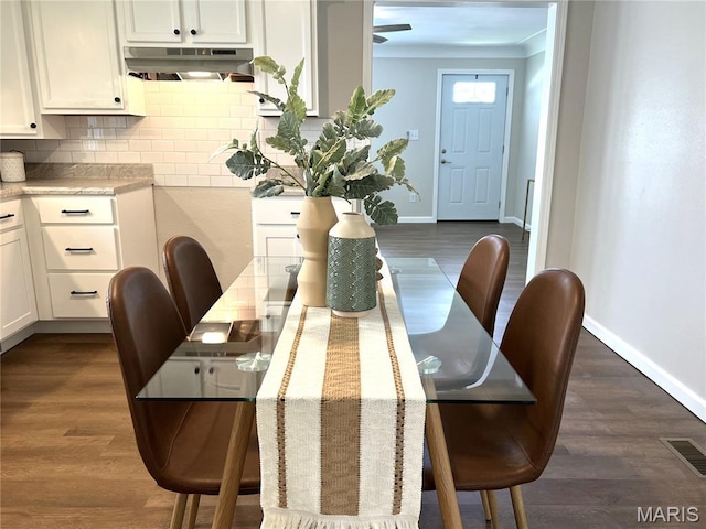 218 Mill St, Bethalto, IL 62010 - dining space featuring dark wood finished floors and crown molding