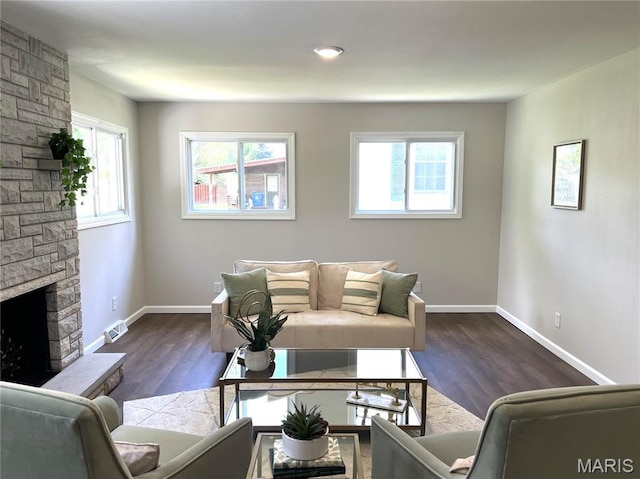 218 Mill St, Bethalto, IL 62010 - living area with healthy amount of natural light, dark wood finished floors, and a stone fireplace