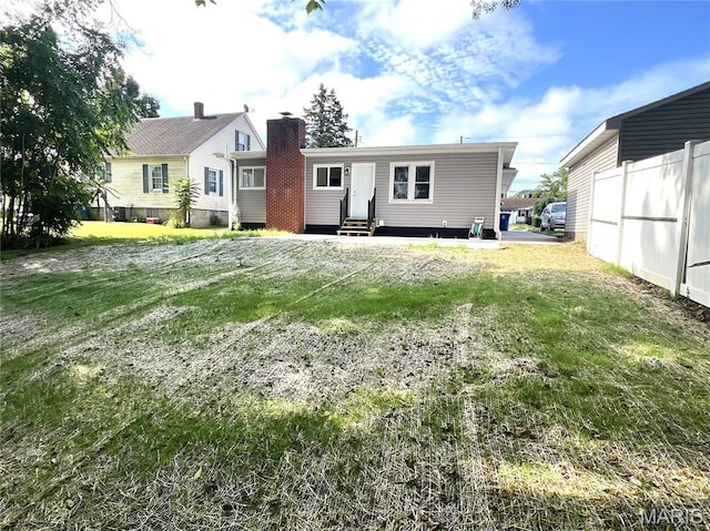 218 Mill St, Bethalto, IL 62010 - back of house featuring entry steps and a chimney