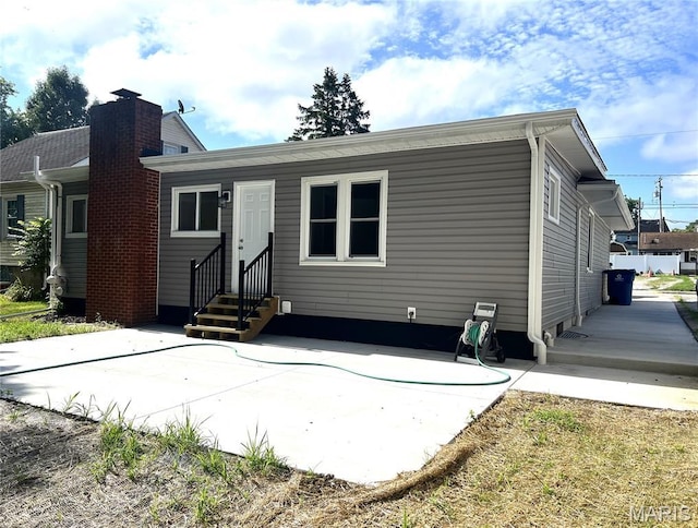 218 Mill St, Bethalto, IL 62010 - back of house featuring entry steps and a patio area