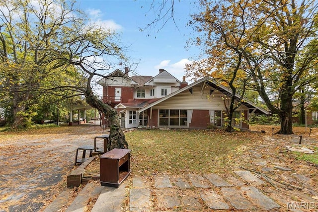 325 N Spring St, Cape Girardeau, MO 63701 - view of front of property featuring a chimney and brick siding