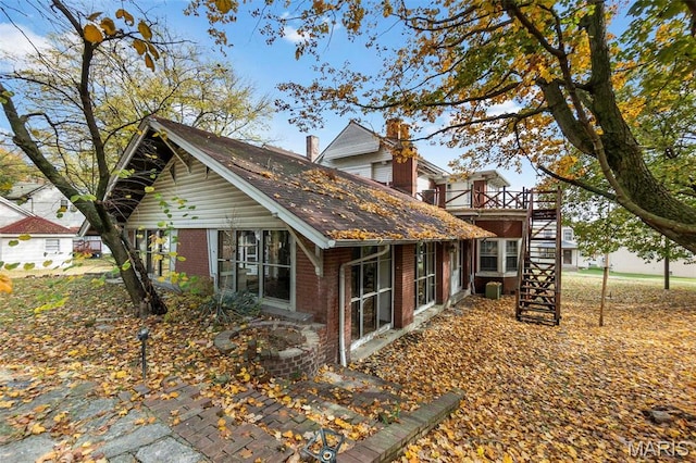 325 N Spring St, Cape Girardeau, MO 63701 - view of side of property featuring brick siding, stairs, and a wooden deck