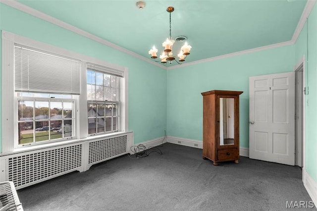 325 N Spring St, Cape Girardeau, MO 63701 - unfurnished room featuring radiator heating unit, a chandelier, carpet, crown molding, and a smoke detector