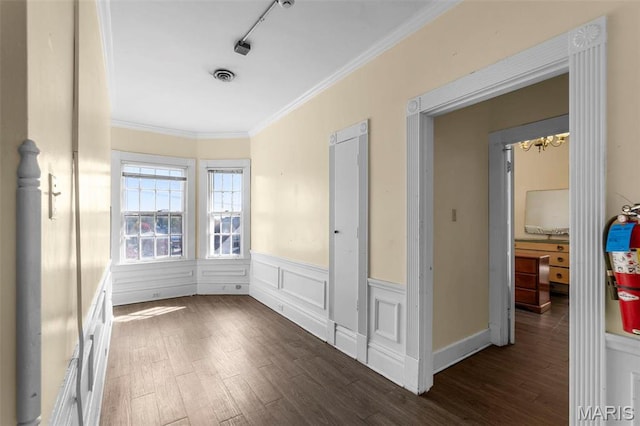 325 N Spring St, Cape Girardeau, MO 63701 - spare room featuring wood finished floors, wainscoting, ornamental molding, a chandelier, and rail lighting