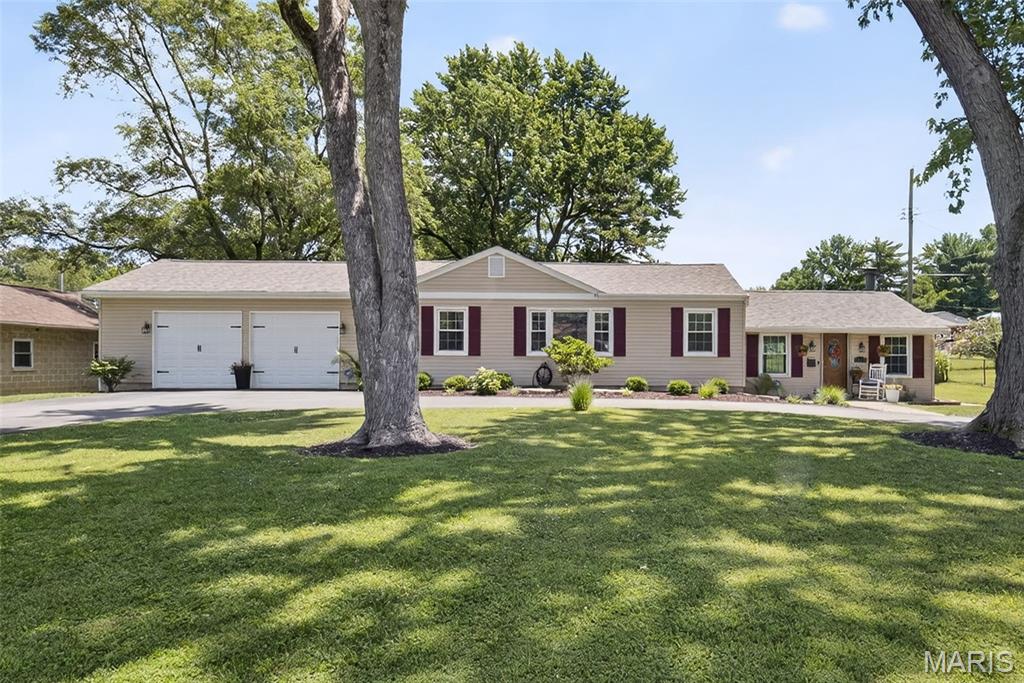 3432 Adie Rd, Saint Ann, MO 63074 - ranch-style house with an attached garage, concrete driveway, and a front lawn
