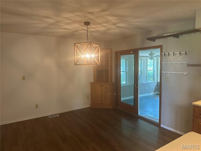 6378 High St, Moro, IL 62067 - unfurnished dining area with a textured ceiling, dark wood finished floors, and a chandelier
