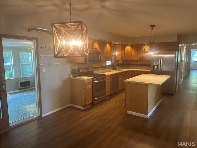 6378 High St, Moro, IL 62067 - kitchen featuring appliances with stainless steel finishes, light countertops, backsplash, dark wood-style flooring, and a center island