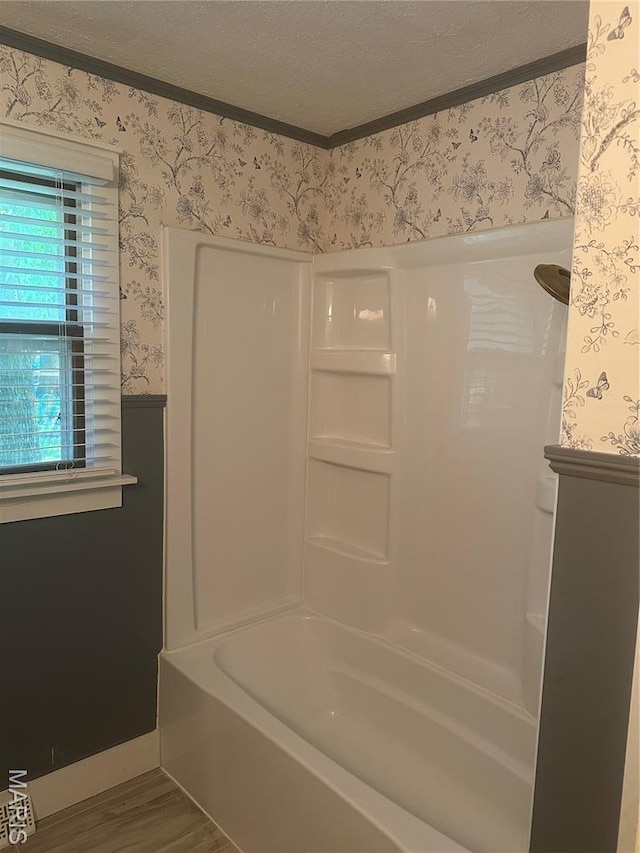 6378 High St, Moro, IL 62067 - bathroom with wallpapered walls, wood finished floors, ornamental molding,  shower combination, and a textured ceiling