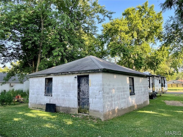 204 E Columbia St, Litchfield, IL 62056 - view of side of home with a yard, concrete block siding, and roof with shingles