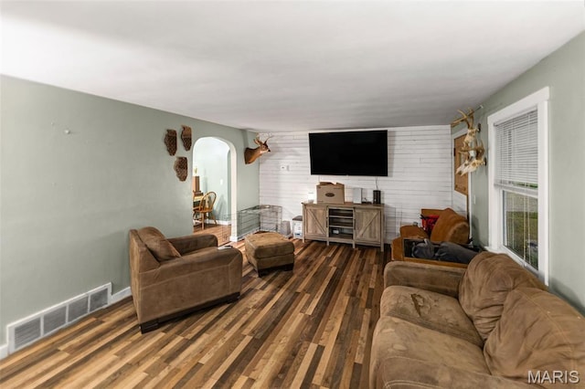 1752 N Bluff Rd, Collinsville, IL 62234 - living room featuring arched walkways, wood finished floors, and wooden walls