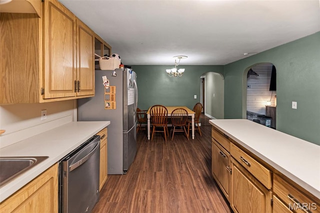 1752 N Bluff Rd, Collinsville, IL 62234 - kitchen with appliances with stainless steel finishes, dark wood-type flooring, arched walkways, light countertops, and a chandelier