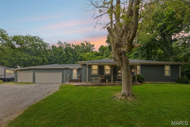 1752 N Bluff Rd, Collinsville, IL 62234 - ranch-style home featuring a front yard, gravel driveway, a garage, and a porch