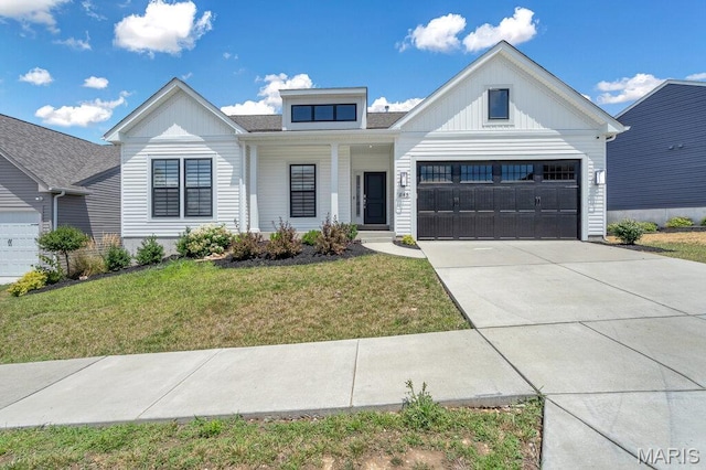 845 Kingston Hills Ct, Fenton, MO 63026 - view of front of home with board and batten siding, a front yard, concrete driveway, covered porch, and a garage