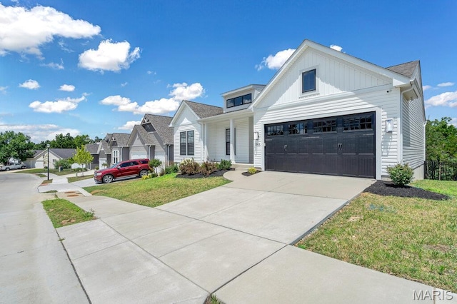 845 Kingston Hills Ct, Fenton, MO 63026 - view of front facade featuring driveway, a front yard, board and batten siding, and a residential view