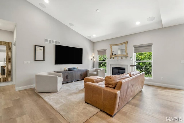 845 Kingston Hills Ct, Fenton, MO 63026 - living area with light wood-style floors, a glass covered fireplace, high vaulted ceiling, and recessed lighting