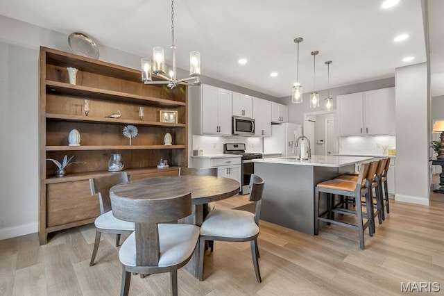 845 Kingston Hills Ct, Fenton, MO 63026 - dining room featuring light wood-type flooring, a chandelier, and recessed lighting