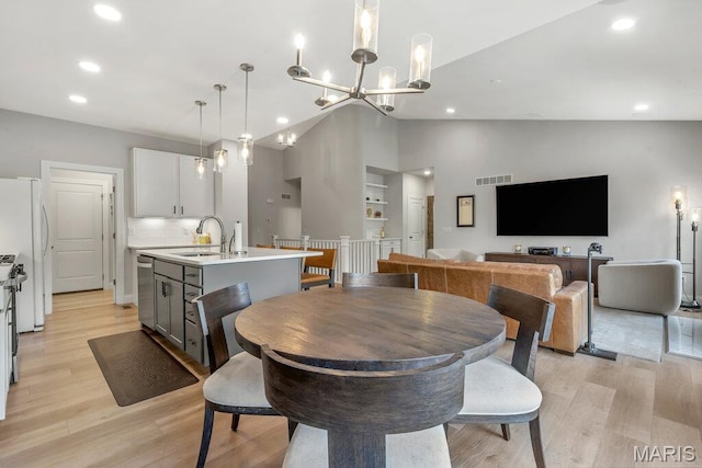 845 Kingston Hills Ct, Fenton, MO 63026 - dining room with light wood-type flooring, a chandelier, recessed lighting, and high vaulted ceiling
