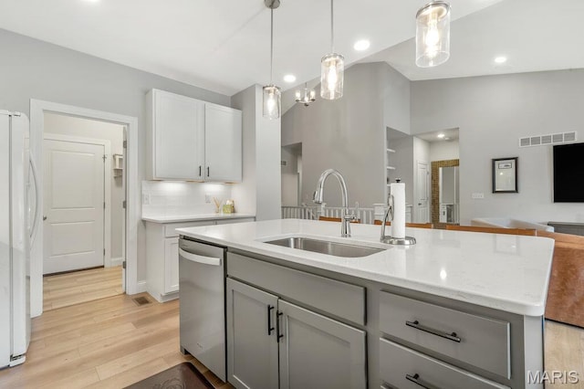 845 Kingston Hills Ct, Fenton, MO 63026 - kitchen with freestanding refrigerator, stainless steel dishwasher, lofted ceiling, gray cabinets, and open floor plan