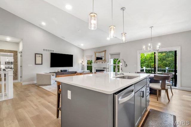845 Kingston Hills Ct, Fenton, MO 63026 - kitchen with appliances with stainless steel finishes, gray cabinets, light wood-style flooring, a fireplace, and a center island with sink