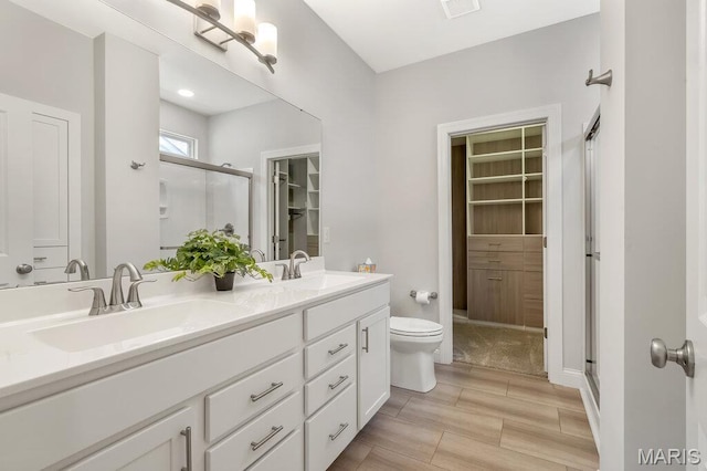 845 Kingston Hills Ct, Fenton, MO 63026 - full bathroom featuring double vanity, a shower stall, and wood tiled floors