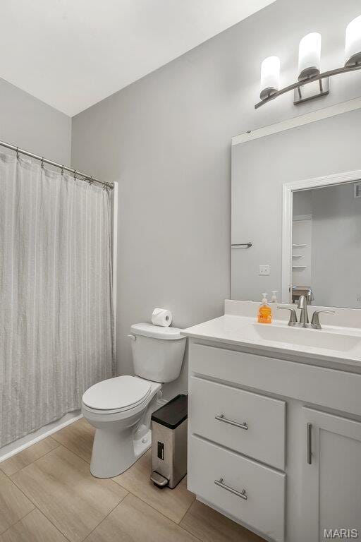 845 Kingston Hills Ct, Fenton, MO 63026 - bathroom with vanity, wood finished floors, and a shower with curtain