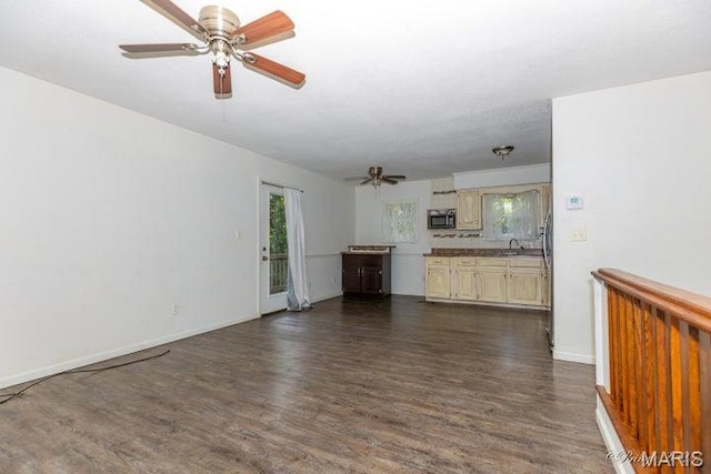 916 Kansas St, Mountain View, MO 65548 - unfurnished living room featuring ceiling fan, dark wood-style flooring, and healthy amount of natural light