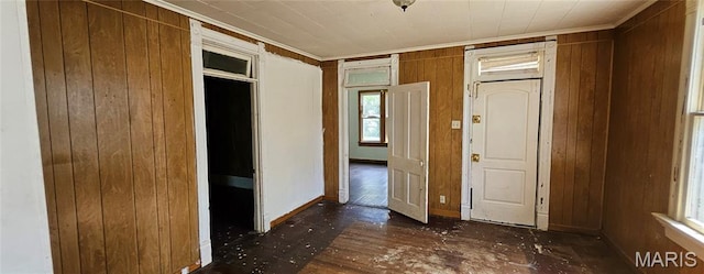 718 2nd St W, Scott City, MO 63780 - unfurnished bedroom with crown molding, wooden walls, and wood finished floors