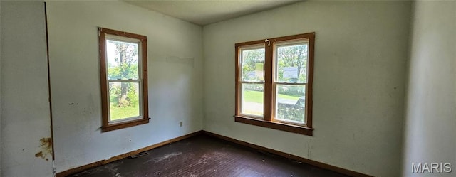718 2nd St W, Scott City, MO 63780 - empty room featuring healthy amount of natural light and dark wood-style flooring