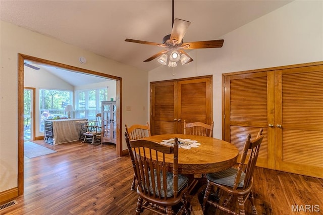 dining area featuring lofted ceiling, wood finished floors, and a ceiling fan