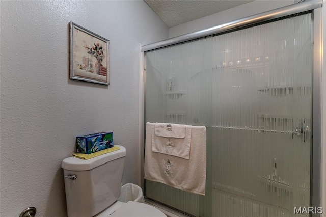 full bath featuring toilet and a shower with shower door