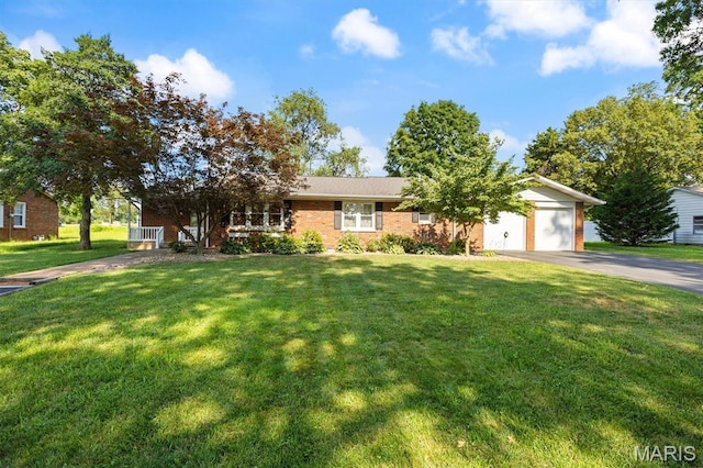 65 Harmon Dr, Lebanon, IL 62254 - view of front of property featuring asphalt driveway, an attached garage, a front yard, and brick siding