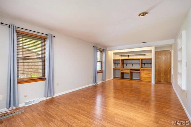 65 Harmon Dr, Lebanon, IL 62254 - unfurnished living room with light wood finished floors and built in shelves