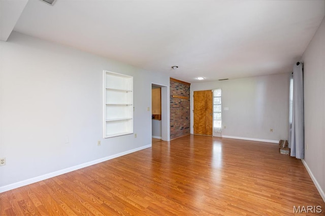 65 Harmon Dr, Lebanon, IL 62254 - empty room featuring built in features and light wood finished floors