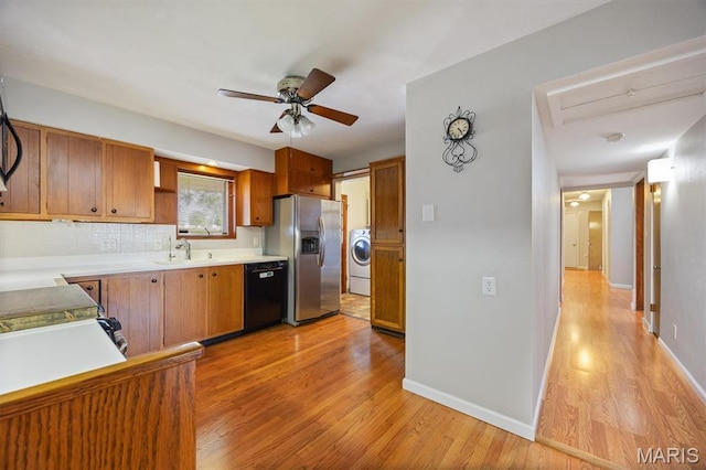 65 Harmon Dr, Lebanon, IL 62254 - kitchen with stainless steel fridge with ice dispenser, dishwasher, light wood finished floors, washer / clothes dryer, and ceiling fan