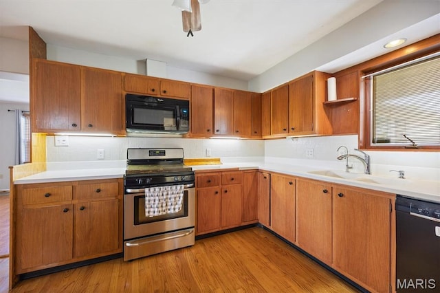 65 Harmon Dr, Lebanon, IL 62254 - kitchen featuring black appliances, light wood-style floors, and backsplash