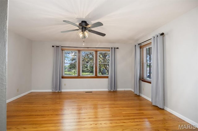 65 Harmon Dr, Lebanon, IL 62254 - empty room with plenty of natural light, light wood finished floors, and a ceiling fan