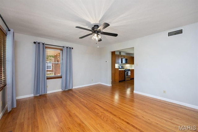 65 Harmon Dr, Lebanon, IL 62254 - unfurnished living room with light wood-style flooring and ceiling fan