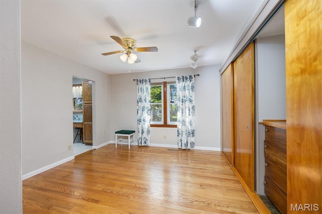 65 Harmon Dr, Lebanon, IL 62254 - empty room with light wood-style flooring, ceiling fan, and rail lighting