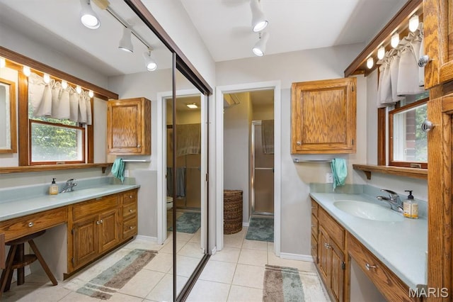 65 Harmon Dr, Lebanon, IL 62254 - bathroom featuring rail lighting, two vanities, tile patterned flooring, and a shower with door