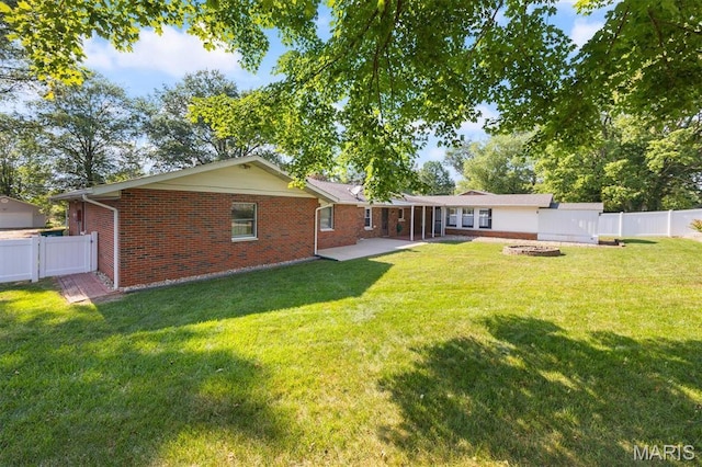 65 Harmon Dr, Lebanon, IL 62254 - back of house featuring brick siding, a fenced backyard, and a patio area