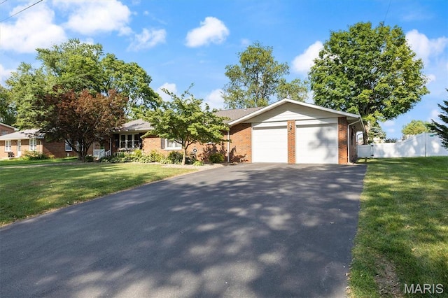 65 Harmon Dr, Lebanon, IL 62254 - view of front facade with asphalt driveway, an attached garage, and brick siding