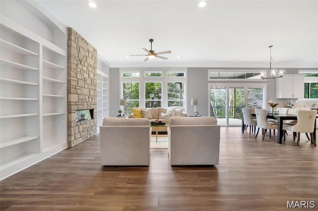 10 Schaper Farms Ct, Foristell, MO 63348 - living room featuring a ceiling fan, recessed lighting, dark wood-type flooring, a fireplace, and a chandelier