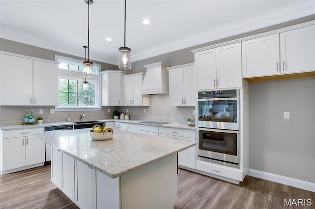 10 Schaper Farms Ct, Foristell, MO 63348 - kitchen with stainless steel appliances, premium range hood, white cabinetry, recessed lighting, and a center island