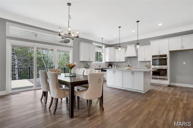 10 Schaper Farms Ct, Foristell, MO 63348 - dining space with dark wood finished floors, a chandelier, ornamental molding, and recessed lighting