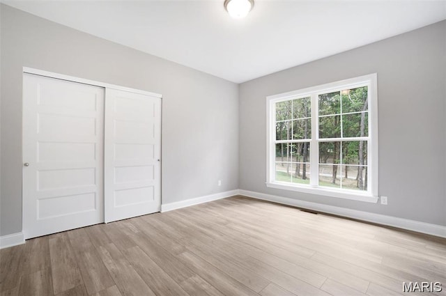 10 Schaper Farms Ct, Foristell, MO 63348 - unfurnished bedroom featuring wood finished floors and a closet